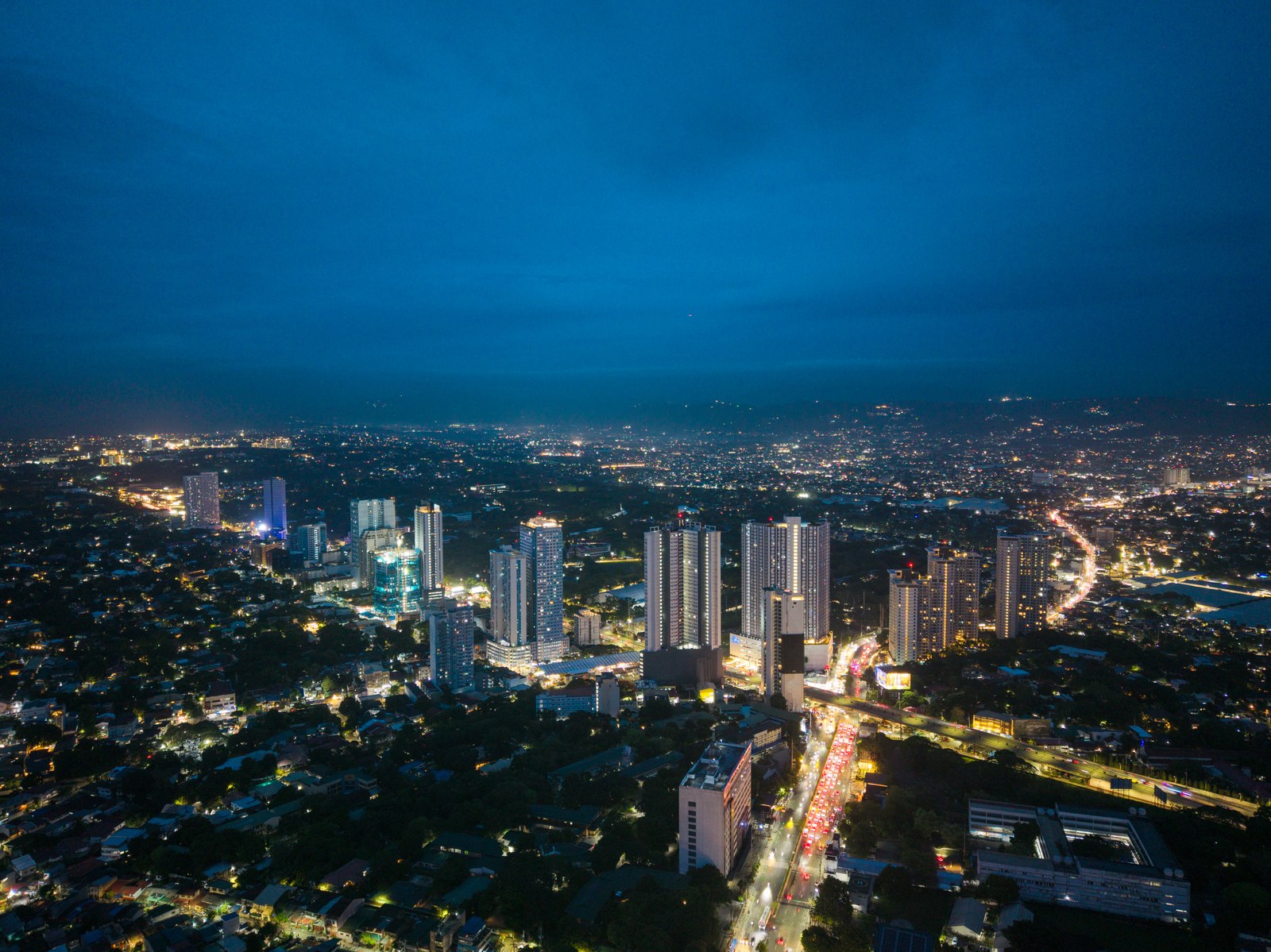 The Oriana twin towers and surrounding Quezon City skyline at night