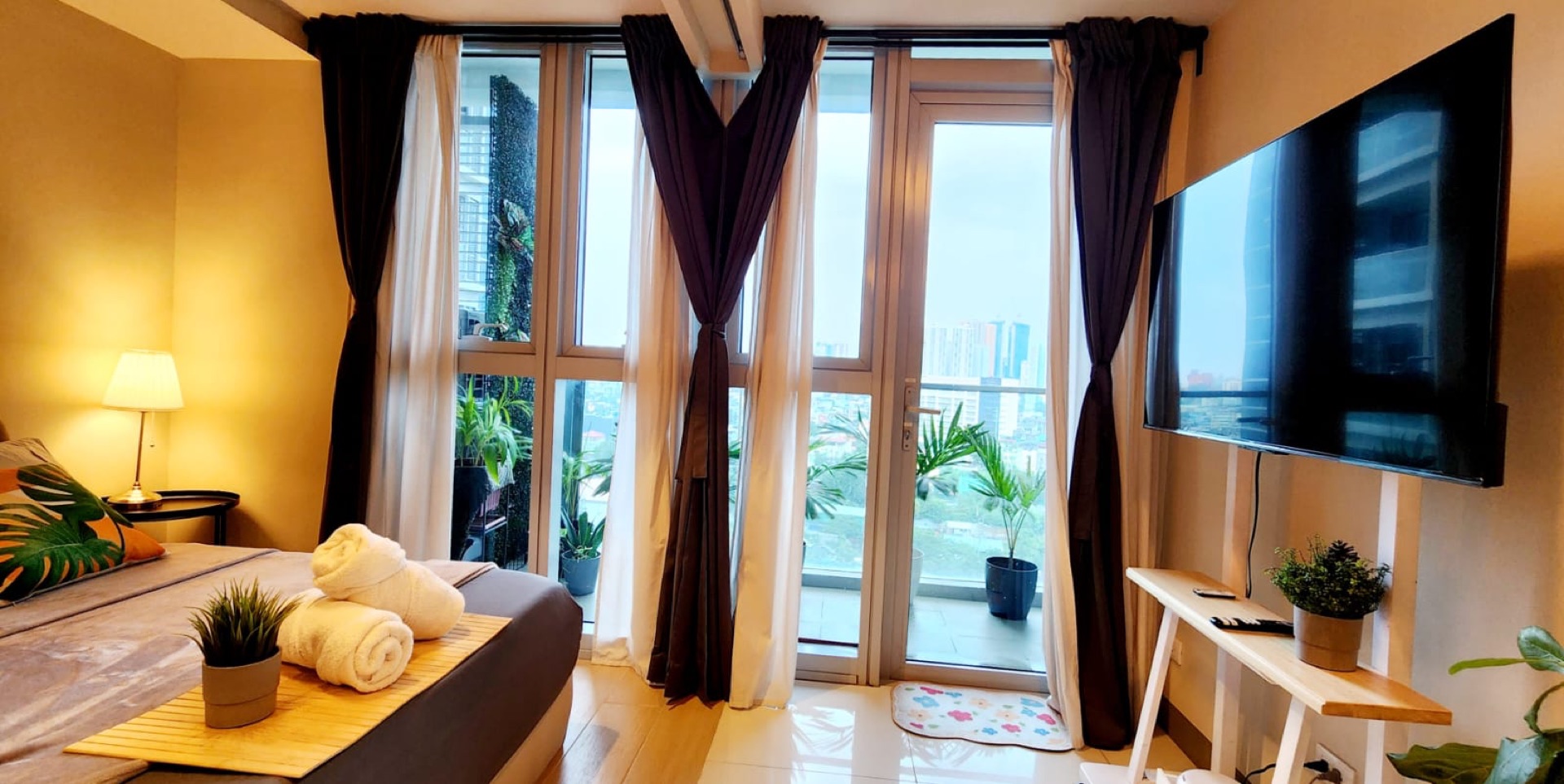 Uptown Parksuites Tower 2 Unit 7U — bedroom in the evening with city lights